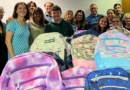 Forte Construction donates stocked backpacks for Helping Hands